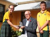 Honour: Roger McFetridge, presenting his ancestor's medals to captains Alyssa Carter and Oscar Merchant, said he hoped they helped provide more "awareness, understanding and reality" about war. Picture: Peter Lorimer
