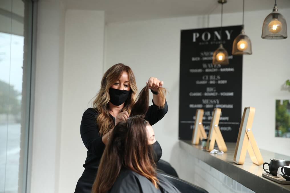 That fresh feeling: Emma Johnson said she and her colleagues were happy to be back in the salon on Monday. Picture: Marina Neil