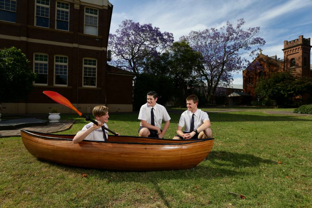 Project: Nathan Smith in his canoe with Braedyn Deamer, who built an automatic plant monitoring and watering system and Riley Hungerford, who built a hydro electric turbine system for a drainpipe. Picture: Jonathan Carroll