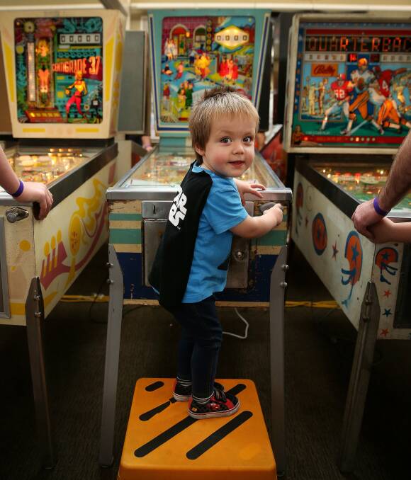 Starting young: Christopher Bradberry from Tamworth, aged two, was one of the youngest "pinheads" at Pinfest. His parents brought two of their machines to the event. Picture: Marina Neil