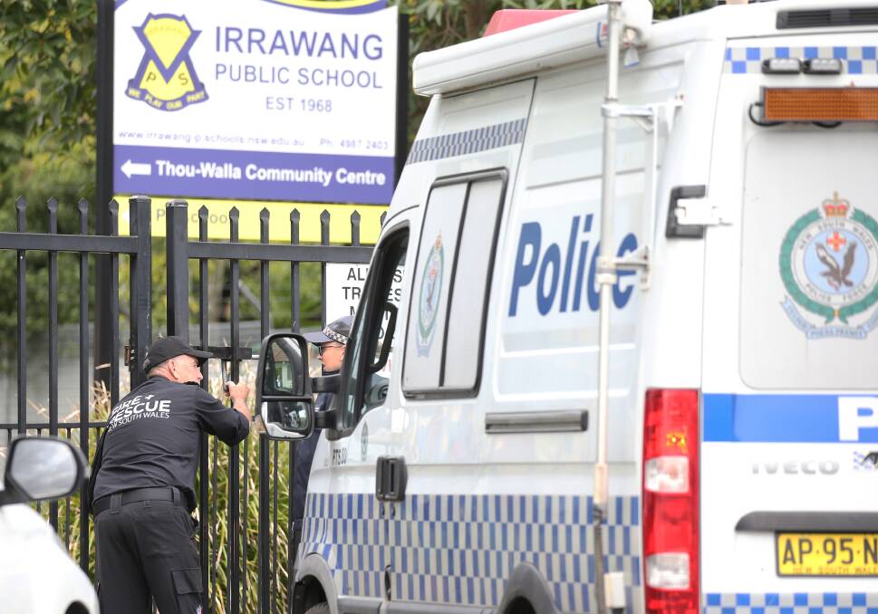 Fallout: Specialist forensic officers examined the crime scene at Irrawang Public School on Monday. More than 25 firefighters battled the blaze for two hours on Sunday night before it was extinguished. Picture: Peter Lorimer