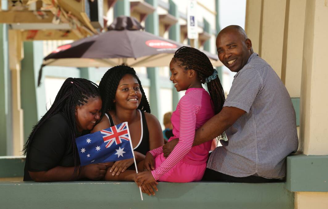 Happy: Marie Jose Niyowera said Australia was "peaceful, powerful and people love each other, which is very important to me,". She is pictured with daughters Memory Bukuru and Ivona Bukuru and husband John Bukuru. The family will gain citizenship on Friday. Picture: Simone De Peak