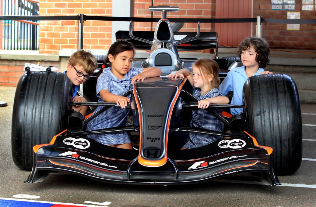 NICE WHEELS: Nash Checkley, Dolly Anja Wilson, Brooke Burdon and Oliver Connor inspect Lewis Hamilton's MP4-21 McLaren F1 racing car. Picture: Phil Hearne.