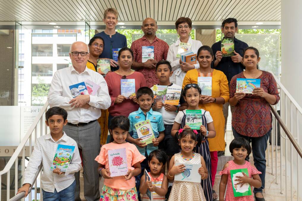 Read about it: The Balar Malar Tamil Educational Association school's students and parents with Kara Matheson (first on top row), Oriana Acevedo (third in top row) and State Librarian Dr John Vallance (first in second row). Picture: Joy Lai.