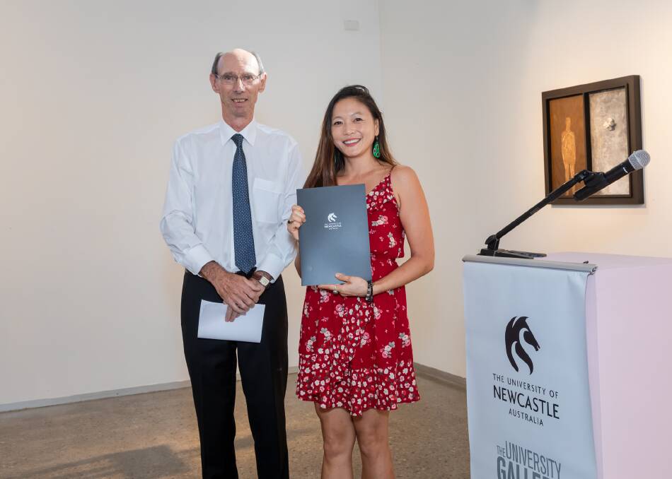 Speaking out: Jennifer Tan with Associate Professor Miles Bore, who retired in 2019, at a school prize ceremony. She said the past few months had been filled with uncertainty and distractions. "It's hard to feel committed to something when you don't know if it's actually going to continue."