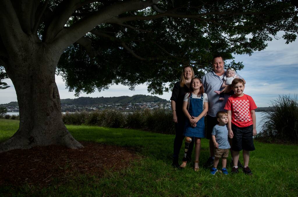 Support: Emilee Pratt 11, with mum Kylie, dad James, and siblings Aaden, 8, Jesse, 22 months and Evie, four months. Emilee used to tell people a shark took her leg, or that she had cut it off with a knife. Picture: Marina Neil
