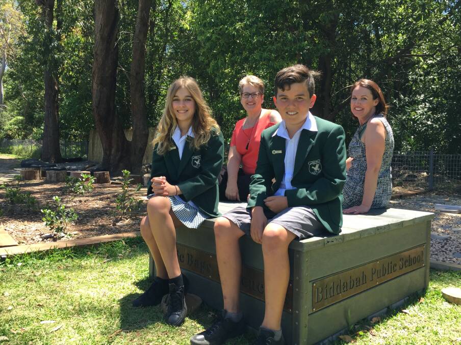 Fantastic plastic: Stella Geres, relieving principal Josie Minett, Dylan Chock and program founder and parent Samantha Cross on the bench, which was installed during the school holidays and unveiled this week. Picture: Helen Gregory
