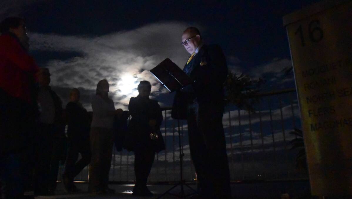 LEST WE FORGET: Newcastle historian David Dial leads Fromelles commemorations on the Anzac Memorial Walk on Tuesday night. Picture: Brodie Owen