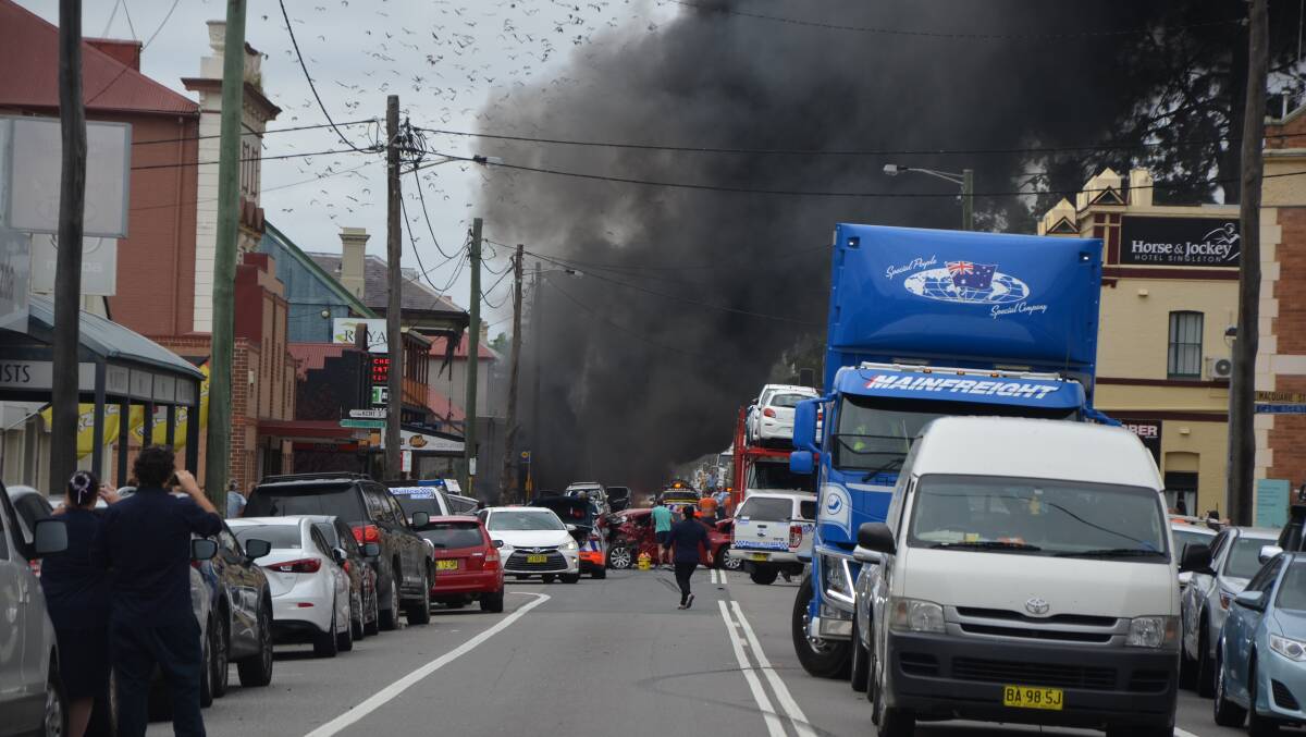 CARNAGE: A truck bursts into flames after careering down Singleton's George Street. Picture: Singleton Argus