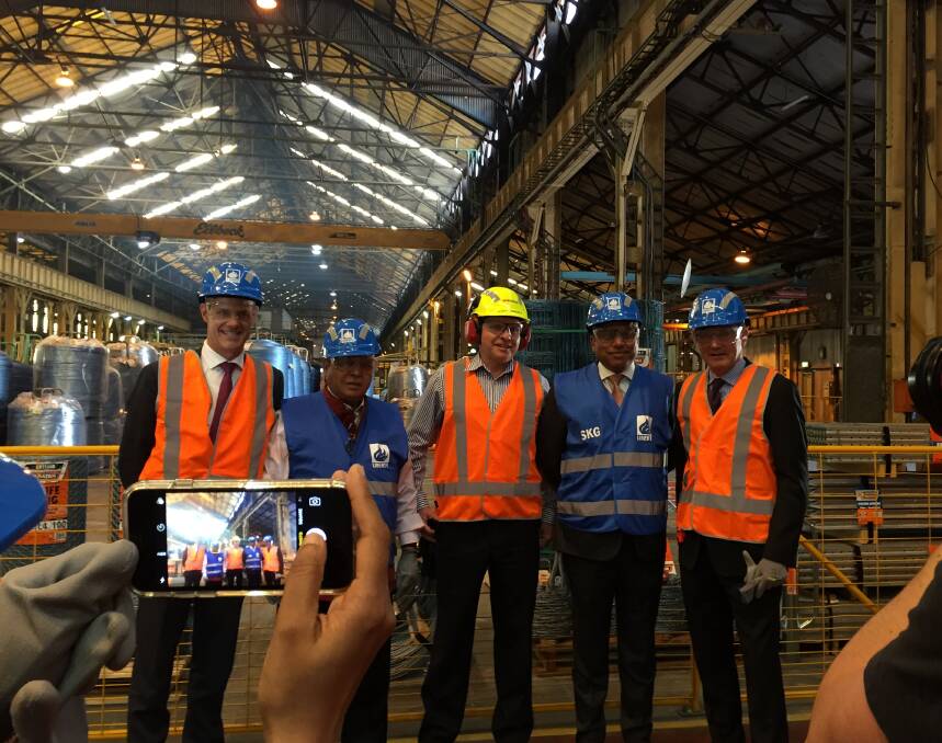 STEELY RESOLVE: Sanjeev Gupta (second, right) toured the Liberty OneSteel mill at Mayfield on Wednesday. “These are all very profitable businesses that just need a little love and care,