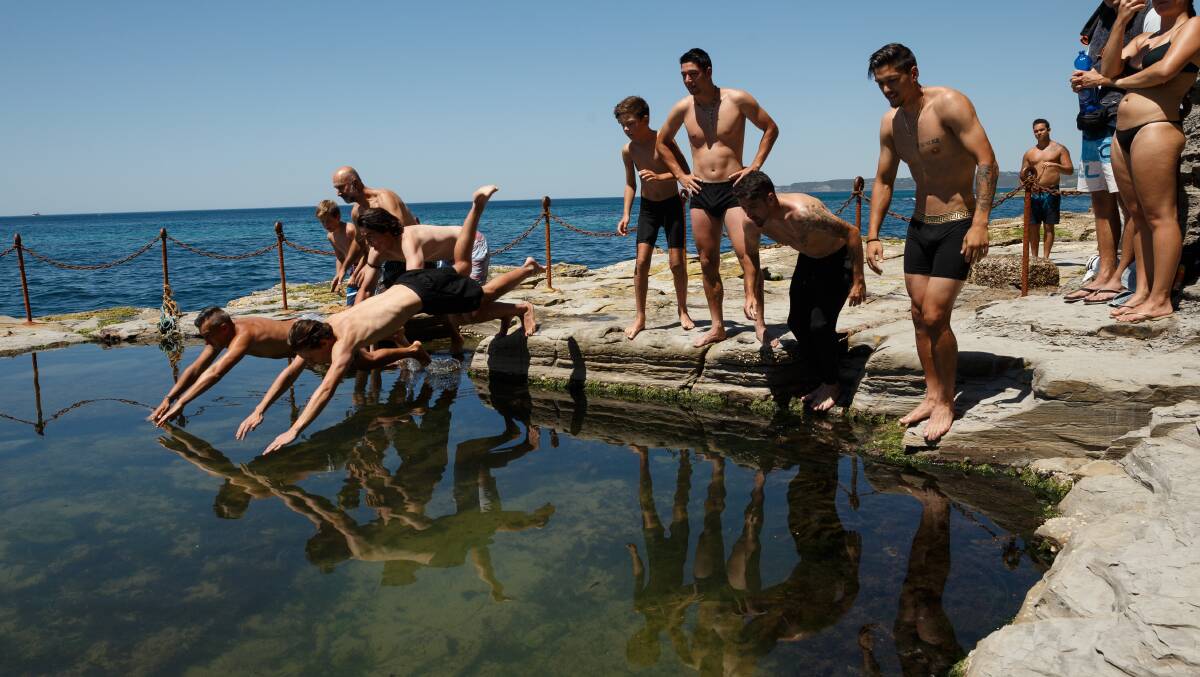 Competitors jump into the Bogey Hole in search of the metal crucifix as part of the Greek community's Blessing of the Waters. Yioti Binos, 17, of Hamilton, got there first. Picture: Max Mason-Hubers