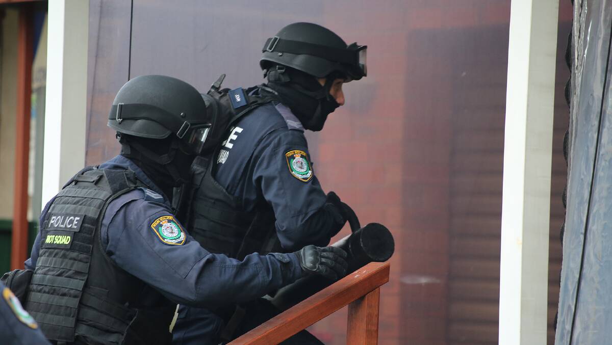 GOING IN: Thirteen people were arrested as part of sweeping dawn raids.