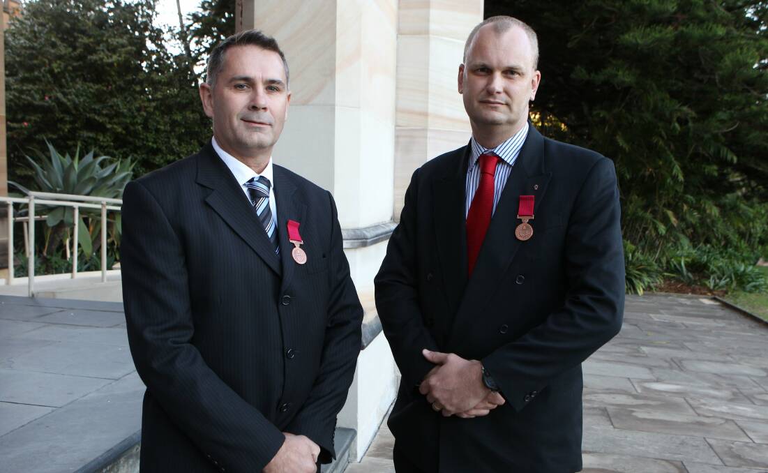 DECORATED: Inspector Little, left, receiving bravery awards in 2010 for pulling a man from a burning car.