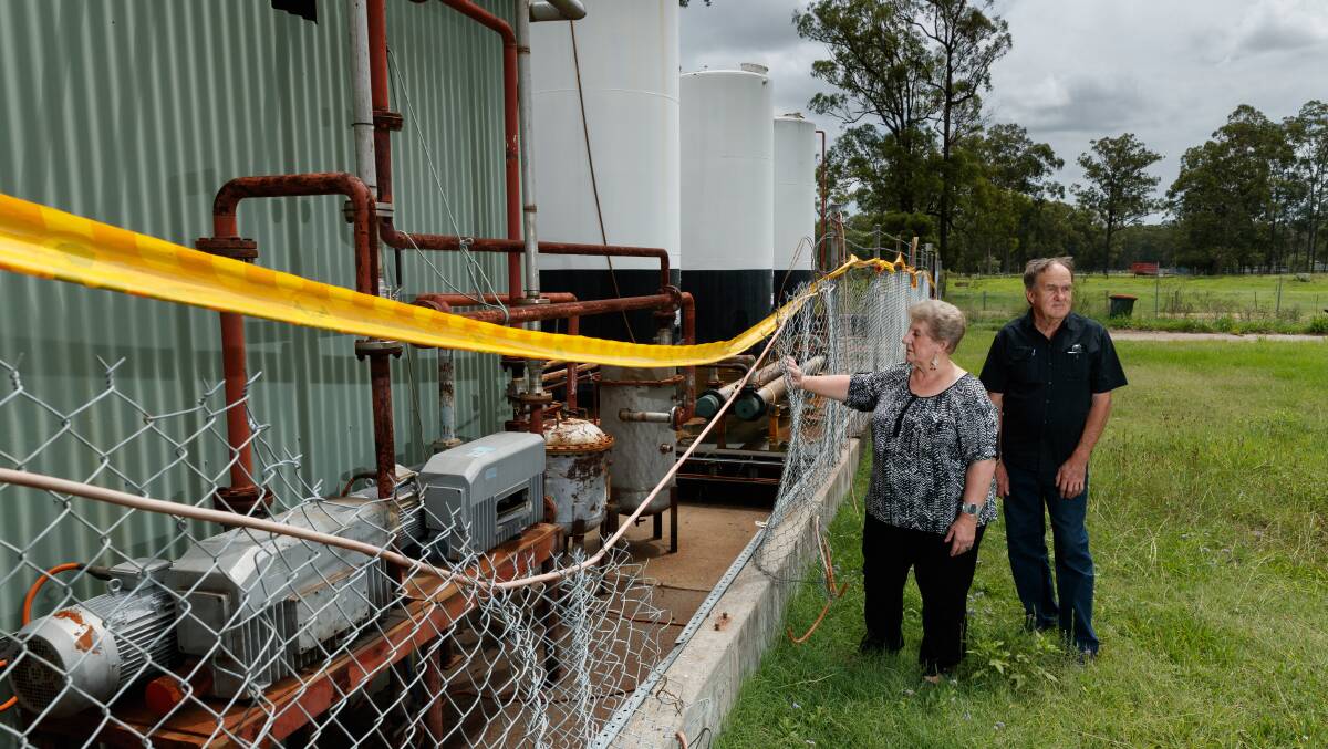 NOT GOOD ENOUGH: Residents Ramona Cocco and Steve Jordan outside the heavily contaminated Truegain waste-oil refinery plant at Rutherford where vandals have cut a large hole in the front fence. Picture: Max Mason-Hubers 