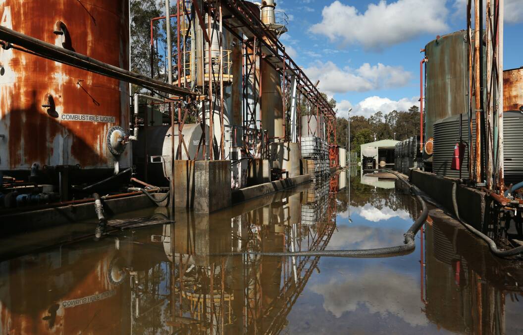 FLOODED: Heavy rain has caused flooding throughout the abandoned Truegain waste oil refinery plant at Rutherford. Picture: Simone De Peak