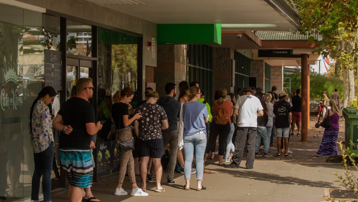 DESPERATE: In scenes reminiscent of the Great Depression, thousands of suddenly unemployed Hunter residents queued outside Centrelink offices across the region this week following mass business shutdowns to combat the spread of COVID-19. Picture: Johnathan Carroll