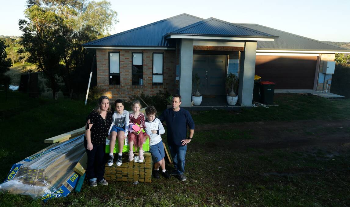 GUTTED: Phillip Kapeller and Rachael Cesnik with their children Loui, 11, Zeke, 9, and Violet, 6. Despite winning a five-year legal battle against a builder that left their new house incomplete and riddled with defects, the family is being forced to complete most of the work themselves. Pictures: Johnathan Carroll and Simone De Peak