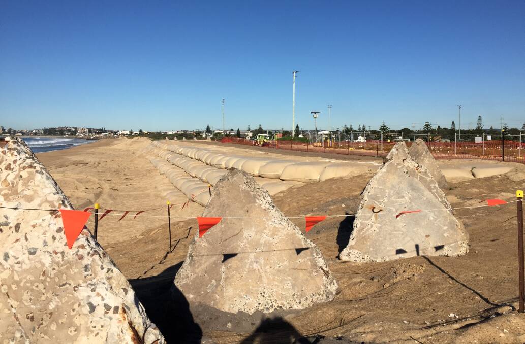 The temporary seawall in July 2019 that was designed to protect an old tip site from spewing rubbish into the ocean.
