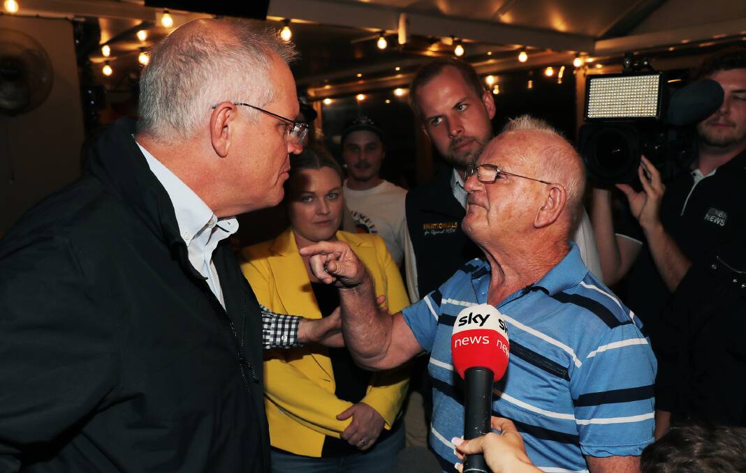 UPFRONT: Scott Morrison confronted at the Edgeworth Tavern by pensioner Raymond Drury. Picture: Peter Lorimer