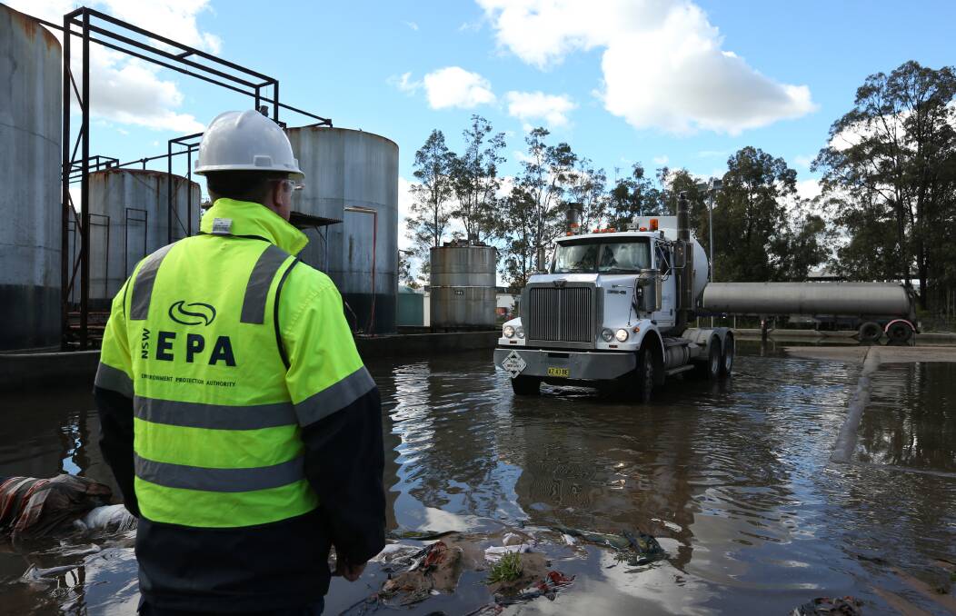 RISK: An EPA officer overseeing a contractor pumping out an underground storage tank at the heavily contaminated Truegain site on Wednesday. Picture: Simone De Peak 