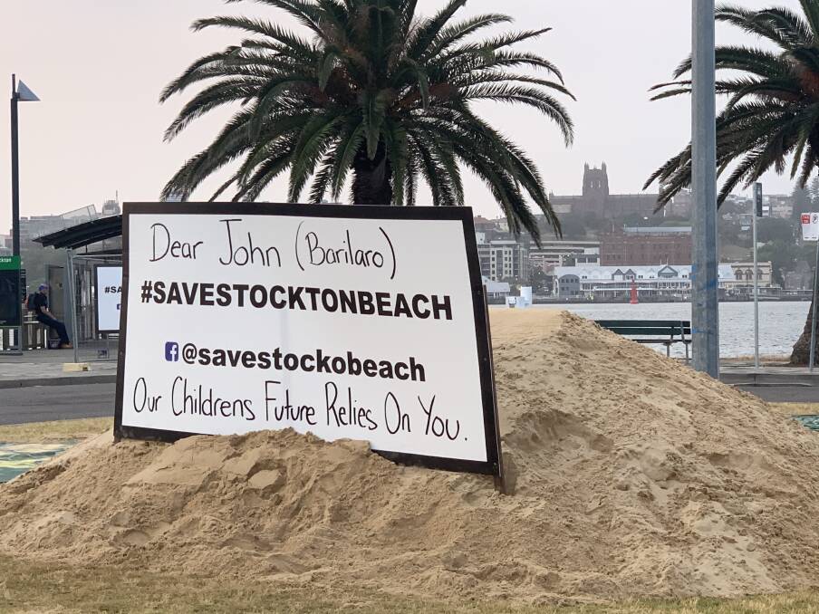 PROTEST: Sand dumped near Stockton ferry terminal calling for action to save the suburb's severely eroded beach. 