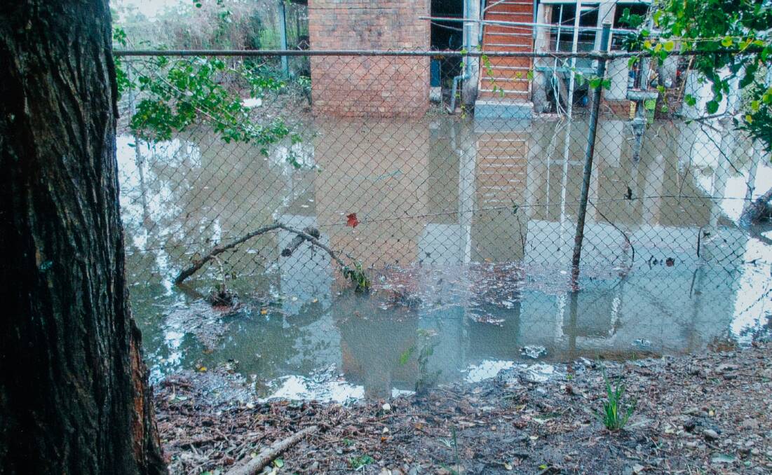 WATER LOGGED: A picture taken from the NSW Infringement Processing Bureau carpark looking at the back of the Downes' Bull St house.