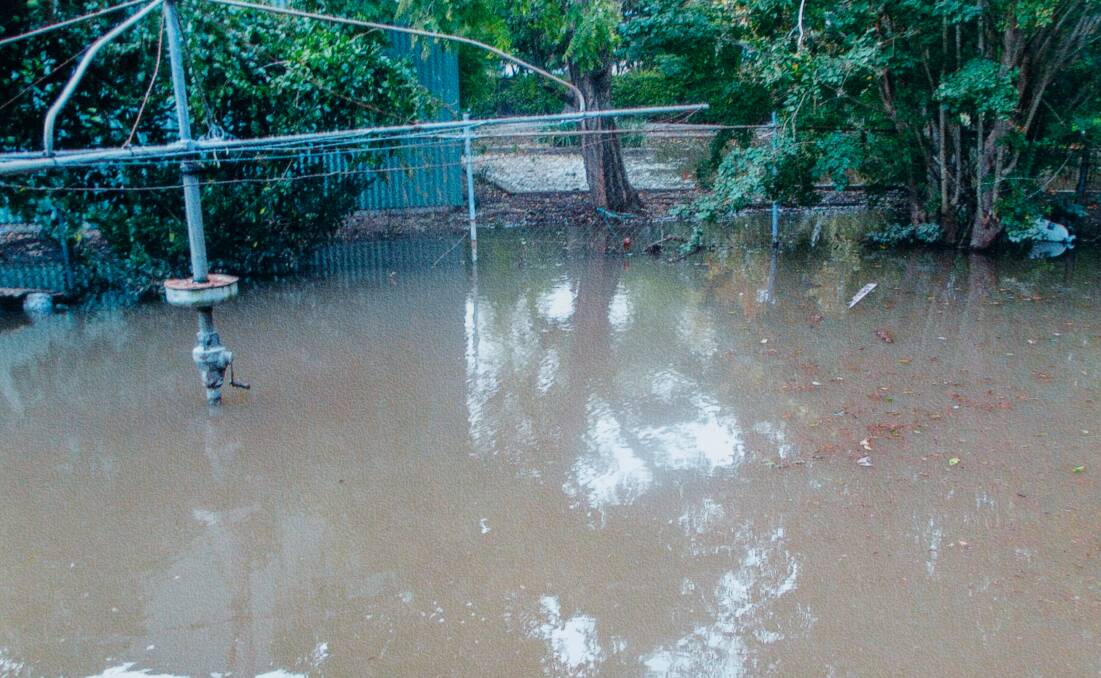 MESS: A photograph taken from the back stairs of the Downes' Maitland house in 2015 showing significant flooding in their backyard