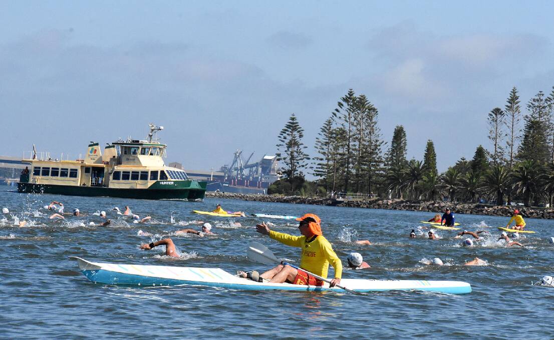 Water safety staff will guide swimmers across the harbour. Picture: Grant Hatch