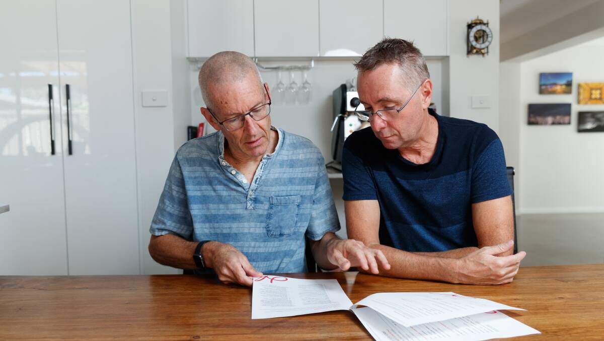 Greig and Glen going over their contract with Henderson Advocacy. 