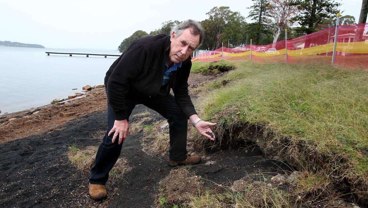 TOXIC: Boolaroo Action Group spokesman Jim Sullivan with black slag found on the lake foreshore in 2015 after heavy storms.