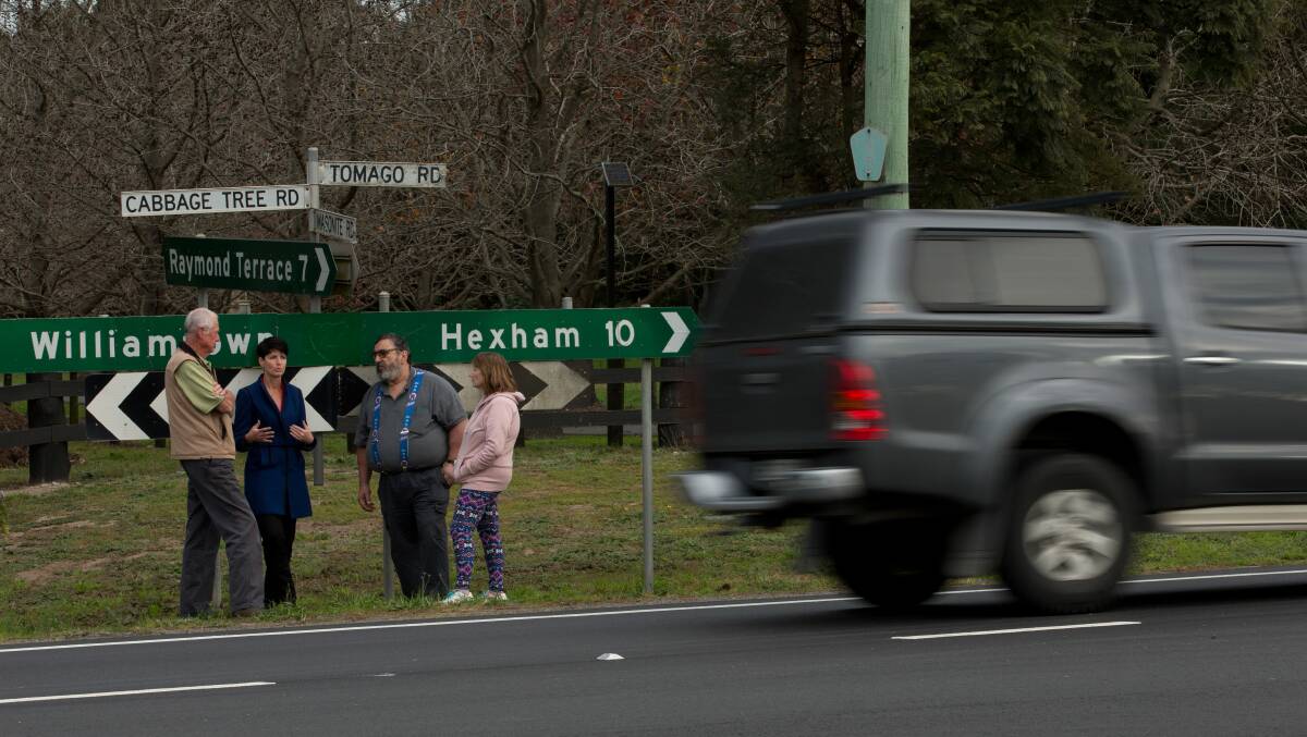 FED UP: Cabbage Tree Rd resident Wayne Sampson, left, Port Stephens MP Kate Washington and Tomago Rd residents Tony and Lea Formosa want the speed zone dropped along a 7.8km stretch of road from 90km/h to 80km/h. Picture: Simone De Peak