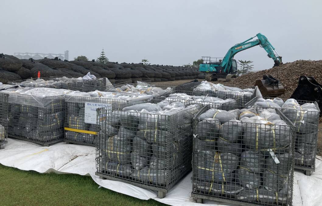 City of Newcastle works off Fullerton St, Stockton, filling large rock bags that will be used along the erosion-stricken coastline.