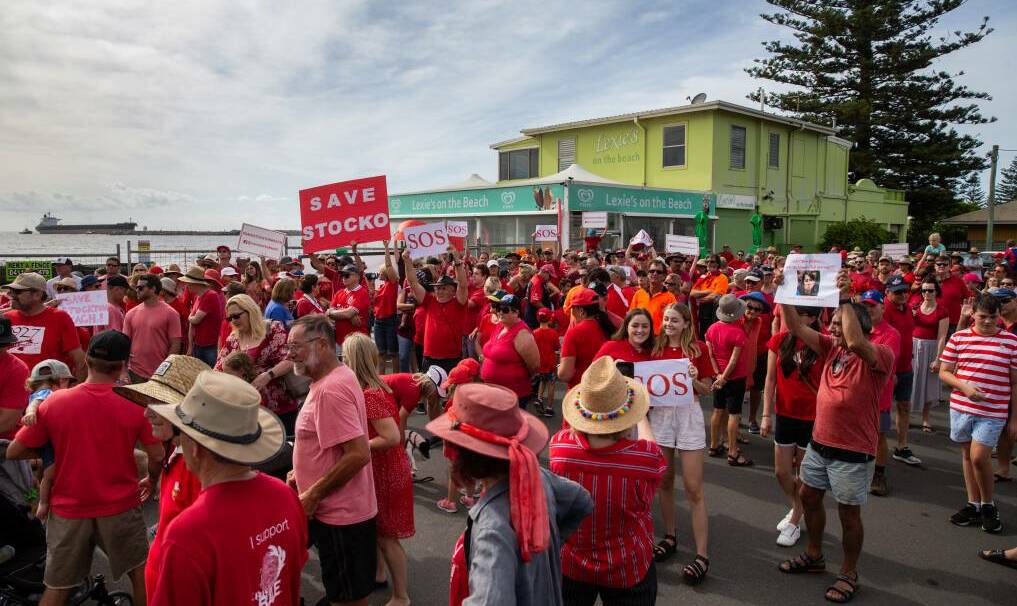 PLEA FOR HELP: The inaugural Stockton beach red line rally was held in February 2020 to raise awareness about the suburb's beach erosion crisis. A second rally will be held on Sunday, July 17, at Stockton breakwater from 10am. Picture: Marina Neil