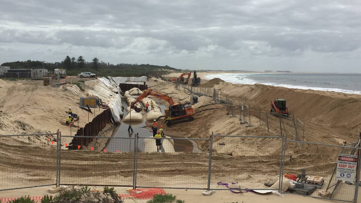CONSTRUCTION: Workers building a temporary sea wall on Stockton beach to protect Hunter Water land from coastal erosion. 