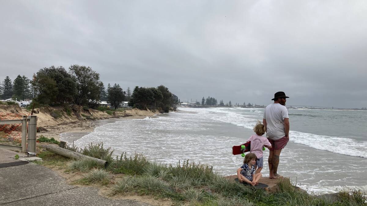 NO ACCESS: Residents look on from Stockton breakwater as more sand is lost from the southern end of Stockton beach. 