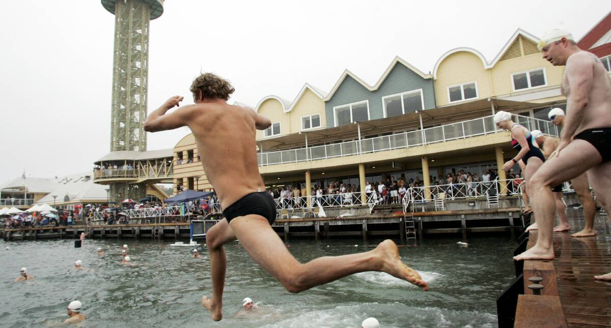 TAKING THE LEAP: Swimmers getting ready for the start of the 2011 Newcastle Harbour Swim. The swim is held on Australia Day each year. Picture: Darren Pateman