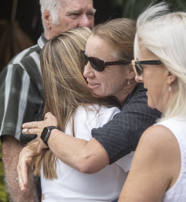 Jayden's aunt Sharelle Harwood hugs his cousin Holly Westcott outside Cairns Coroners Court. Picture: Brian Cassey