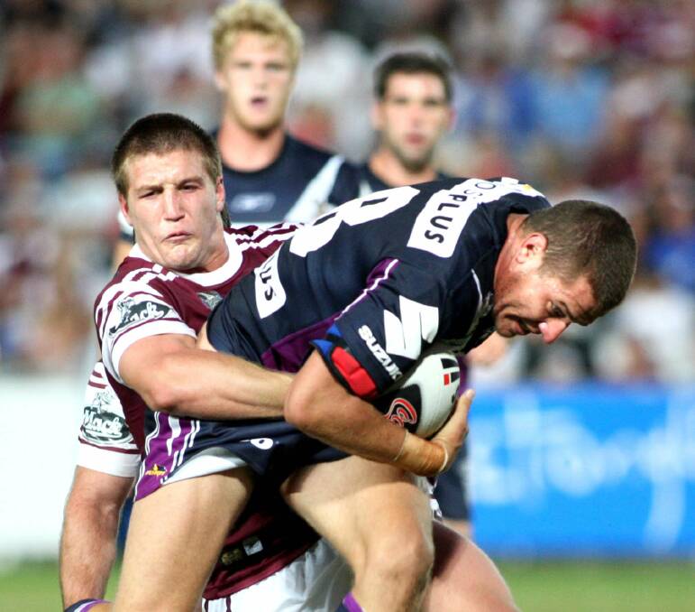 DETERMINED: Lucas Miller forcing his way through the Manly defence during a National Rugby League game at the Central Coast when he was playing for the Melbourne Storm in 2008.