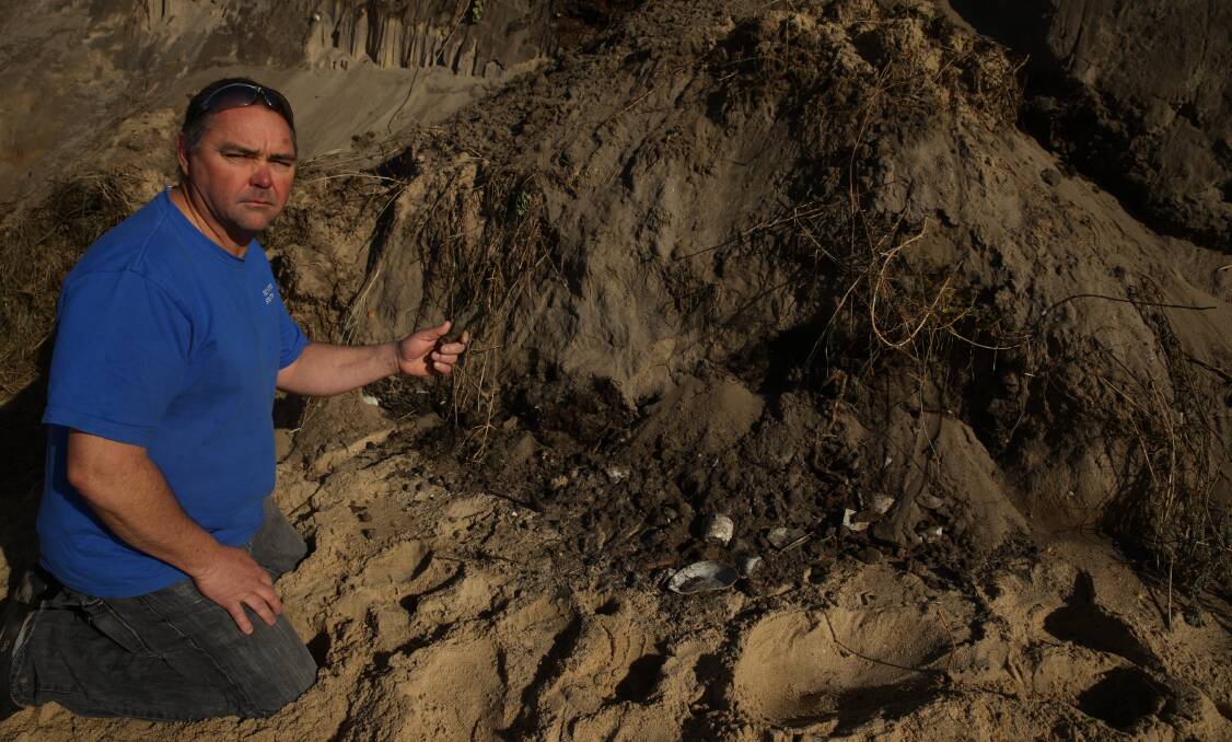 DISGUSTED: Stockton resident Shannon Hancock at the site of another old tip site uncovered on Stockton beach. This smaller illegal tip site is located near Stockton child-care centre that is under threat from erosion. Picture: Jonathan Carroll