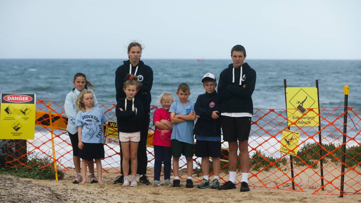 WHERE'S OUR BEACH: Stockton Surf Life Saving Club juniors, from left, Tilly Sinclair, Clare Bernard, Neely Sinclair, Rooney Freeman, Indi, Nate and Billy Bernard and Percy Sinclair. 