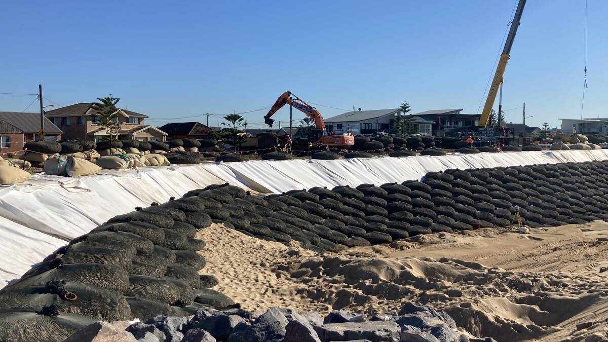 MAJOR WORKS: City of Newcastle contractors are placing 1100 rock-filled bags along Stockton beach, near Barrie Crescent, to halt erosion and protect properties. 