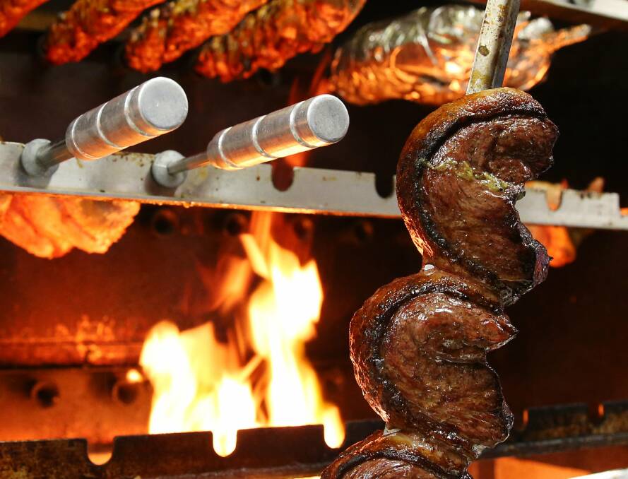 SIZZLE: Some of the meat selection being cooked over the flame grill.