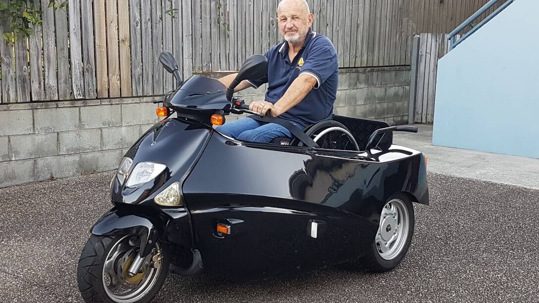 REVVED UP TO GO: Bevan Kearsley with his converted, fuel engine-powered scooter on which he plans to do a loop of the state - and beyond. His journey is being supported by Spinal Life Australia and Carers Queensland.
