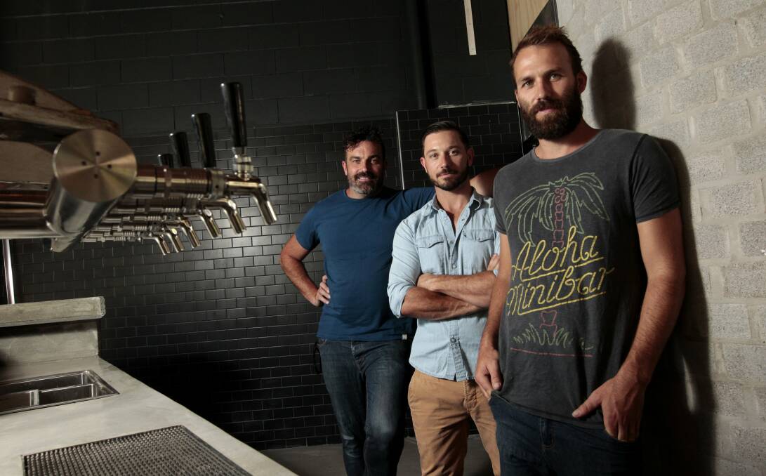 Bar men: Silverchair bass player Chris Joannou, centre, with then business partners Chris Johnston, right, and Tim Leveson in January 2014, just before The Edwards opened in Parry Street. Picture: JONATHAN CARROLL