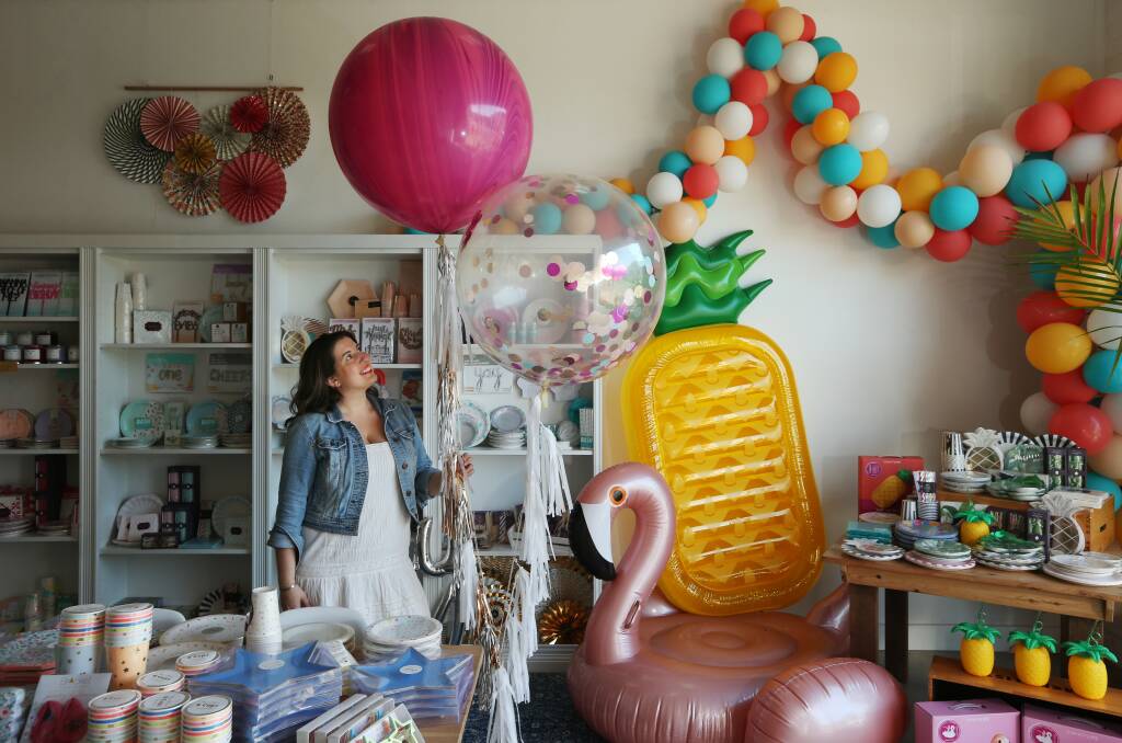 Life of the party: Andrea Ciotti holding a confetti balloon in her luxury party supply store Palm & Pine. Picture by Simone De Peak