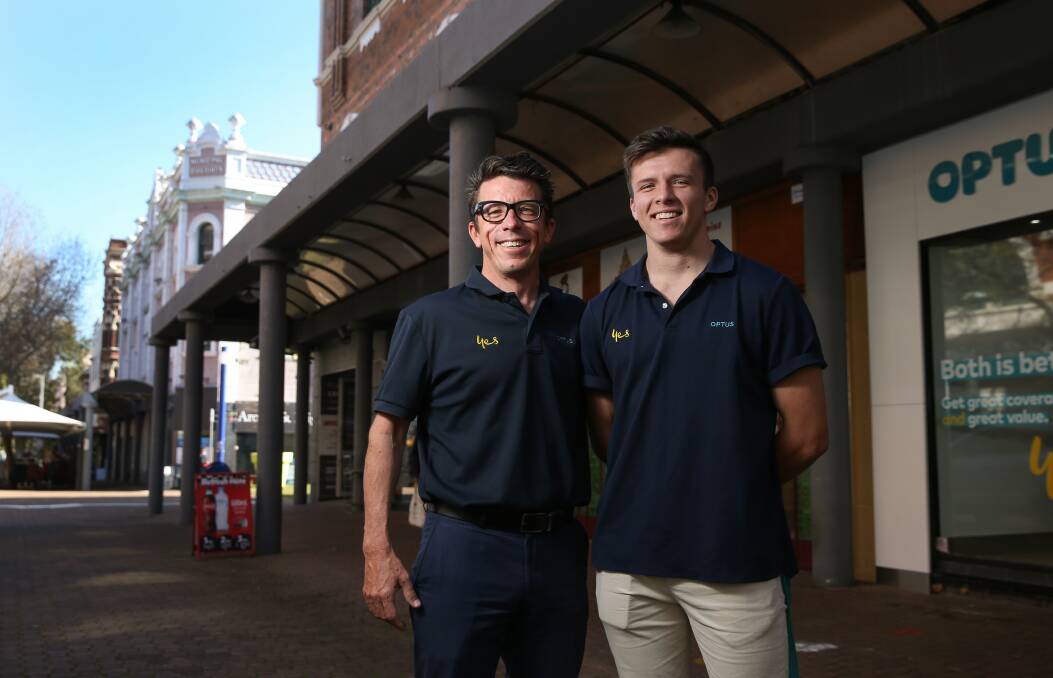 Longevity: "Twenty years, I never would have thought it," says Simon Hasson, left, with son Kingston at their Optus store in Hunter Street mall. 