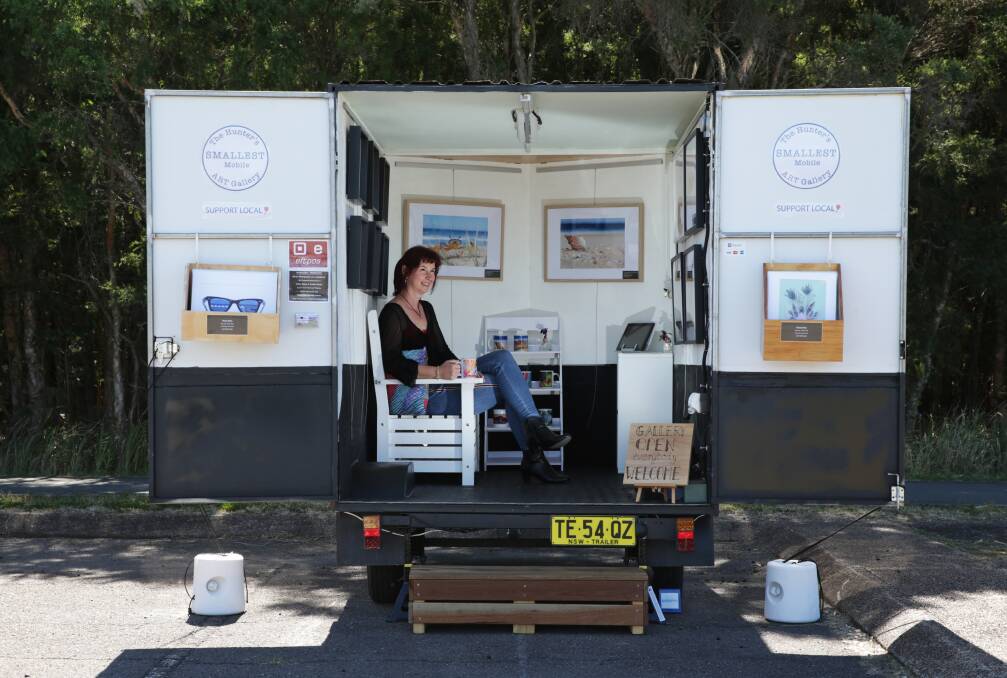 Art to go: Lake Macquarie artist Martina Carney in her business - the Hunter's Smallest Mobile Art Gallery. Picture: Simone De Peak