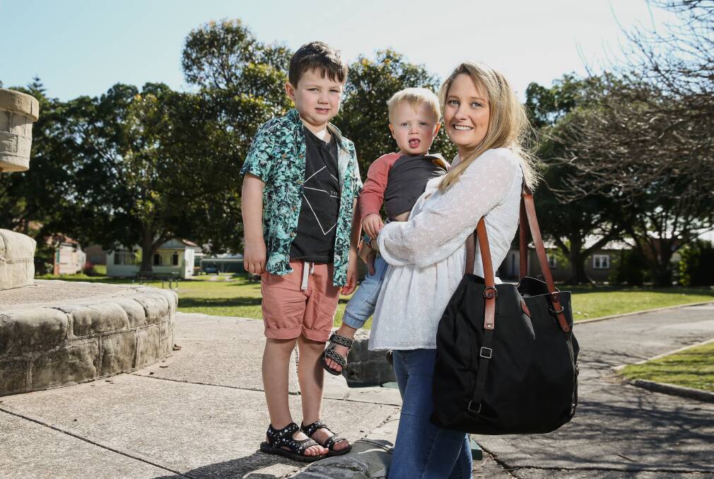 Designs of her own: Newcastle mum Amy Stanton with Mack, 18months, and Archer, 4, and one of her Arch bags. Picture: Marina Neil. 