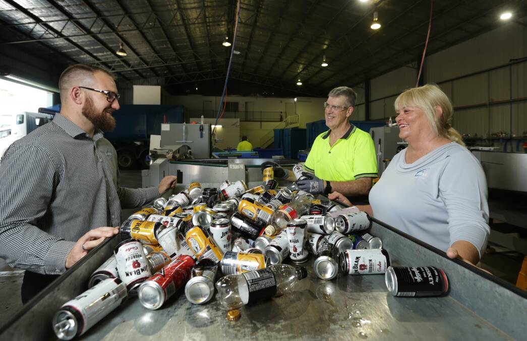 Trash for cash: Cardiff RSL's Terry Balchin, left, and Karen McCraw, with Vinnies Container Deposit Centre's Rob Monkley. Picture: Simone De Peak 