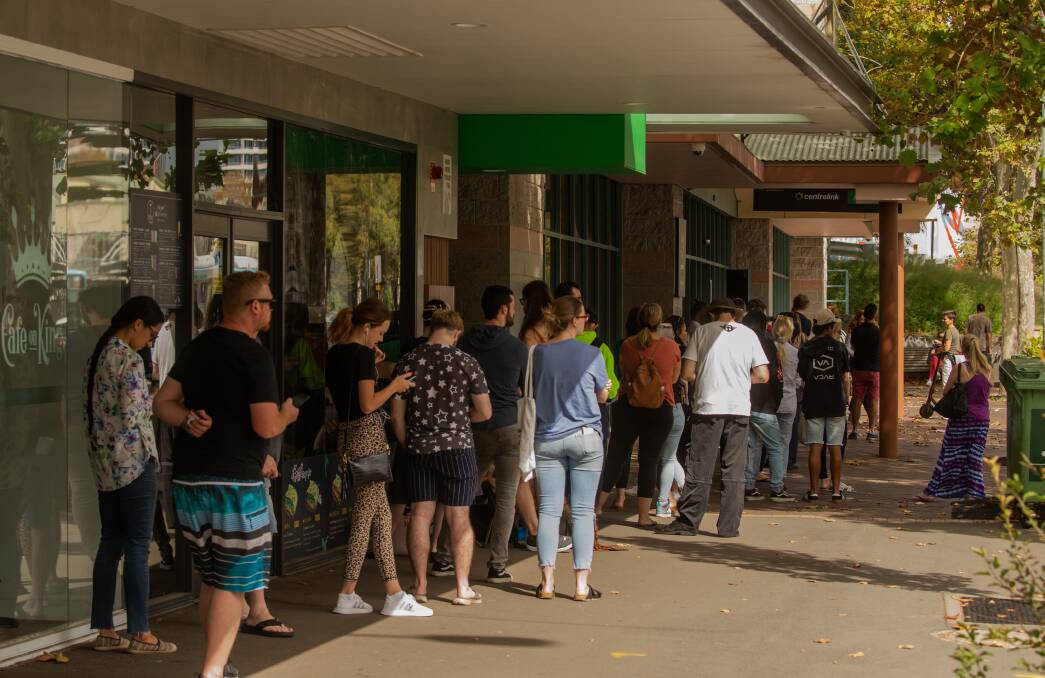 Grim times: The line at the Centrelink office in King Street, Newcastle, in late March as the Government announced its JobKeeper package. Picture: Marina Neil. 